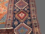 two oriental rugs with different colors and patterns on them