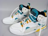 pair of white sneakers with blue and yellow accents on a white surface