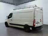 a white van parked in a room with a ladder on the roof