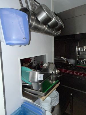 pots and pans hanging from the ceiling in a kitchen