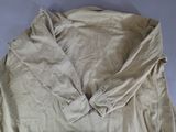 an image of a tan jacket laying on top of a white table