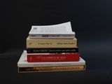 three books stacked on top of each other on a table