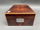 a small wooden box with a metal latch on the lid