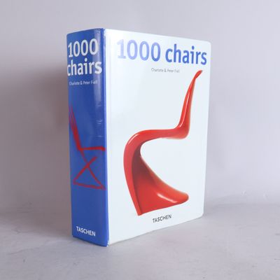 a book that has a red chair in front of it