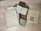 many old books on a table with a book open