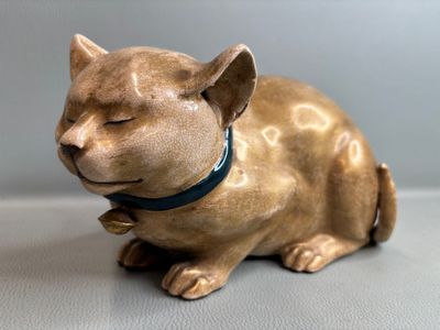 a figurine of a cat sitting on a table