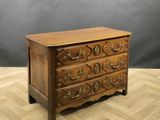 a wooden chest of drawers on a wooden floor