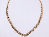 a gold necklace with a heart charm hanging from it