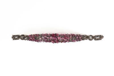 un gros plan d'un bracelet rose et noir sur fond blanc