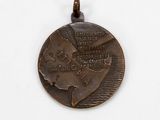a bronze medal with a picture of a woman on it