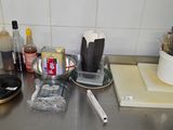 stainless steel counter top with utensils and other kitchen items on it