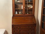 a dresser and a bed in a small room