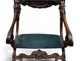 une vieille chaise en bois avec une assise rembourrée verte
