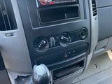 a dashboard of a truck with a radio and a steering wheel