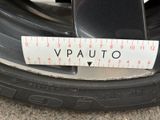 a measuring tape on the rim of a car