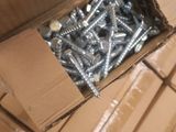a box full of screws sitting on the floor