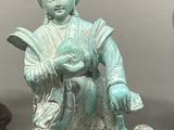 a statue of a woman sitting on top of a wooden box