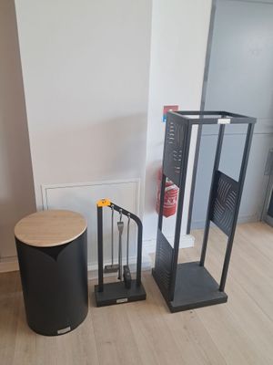 a black trash can and a black trash can in a room