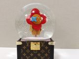 a snow globe with a teddy bear inside of it