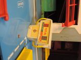 a yellow and red device attached to the side of a blue bus