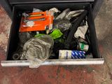 a drawer full of assorted items on the floor