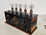 a wooden box with a bunch of light bulbs on top of it