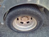 a close up of a flat tire on a truck