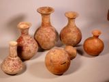 many vases that are sitting on a table