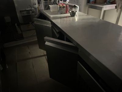a kitchen with a sink and a refrigerator in it