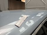 a ruler on the hood of a car that is parked in a garage