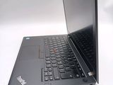 a black laptop with a red button on the keyboard