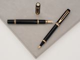 an image of a pen and a rollerball pen on a piece of paper