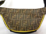 a close up of a brown and black purse on a white surface