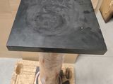 a black table with a black top and a brown base