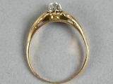 a close up of a gold ring with two diamonds on it