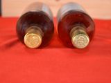 two bottles of wine that are sitting on a table