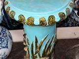 two vases and a table in front of a painting