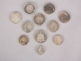 a lot of coins that are on a white surface