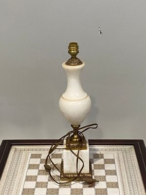 a lamp that is sitting on a table with a checkered table cloth