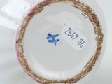 a white vase with a blue and gold design on it