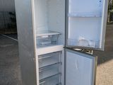 an open refrigerator that is sitting outside on the ground