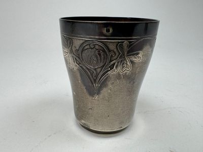 a black and silver vase sitting on a white table