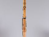 a wooden clarinet with a black top and a white background