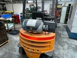 a forklift in a warehouse with many boxes on the floor
