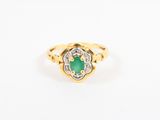 a gold ring with an emerald stone and diamonds
