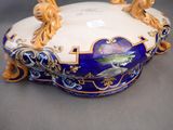 a blue and white bowl with gold decorations on it