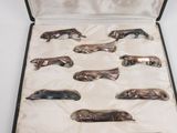 a case with six silver spoons in it on a table