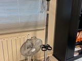a fan sitting on the floor in front of a window
