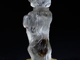 an image of a glass figurine of a bear holding a banana