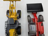 two toy vehicles that are next to each other on a table